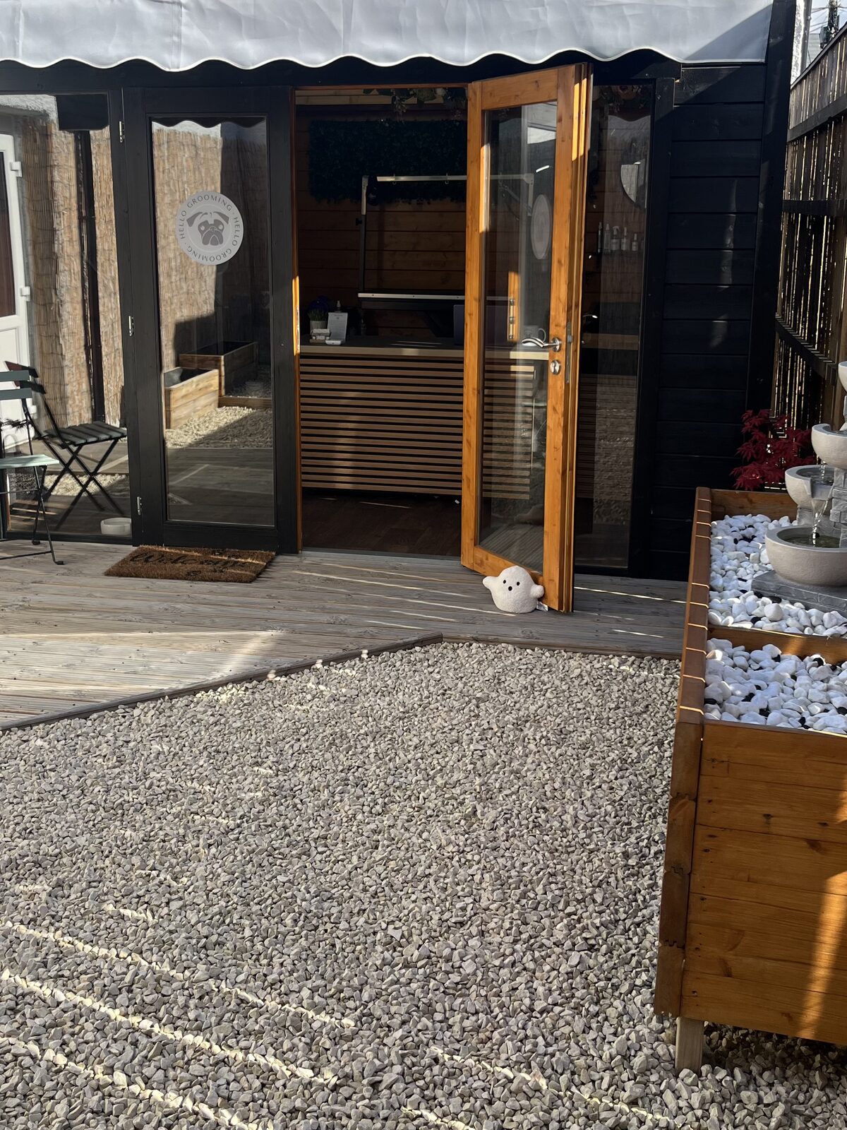 Outside the Hello Grooming cabin salon with decking and courtyard